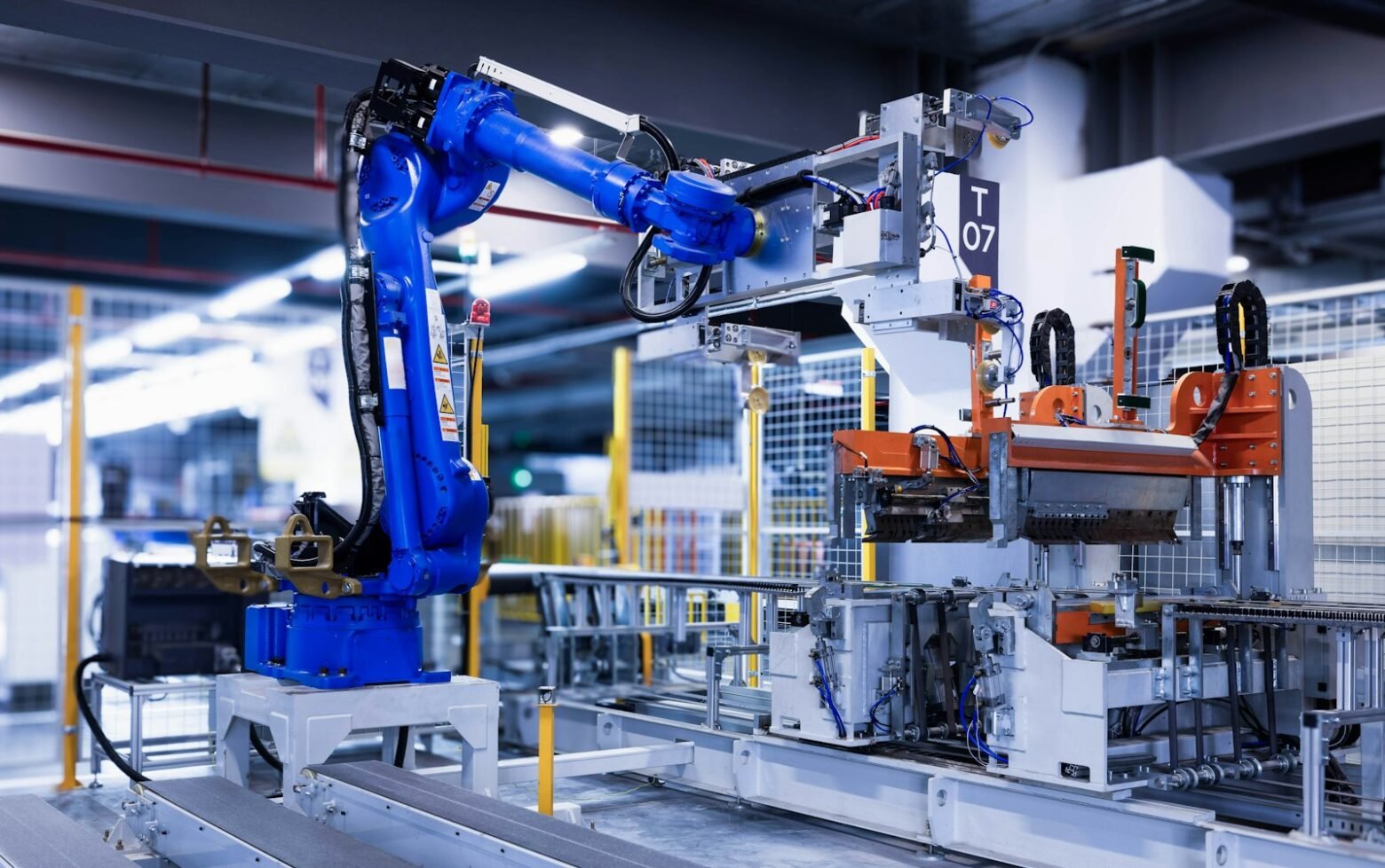 Blue industrial robot arm in a manufacturing facility