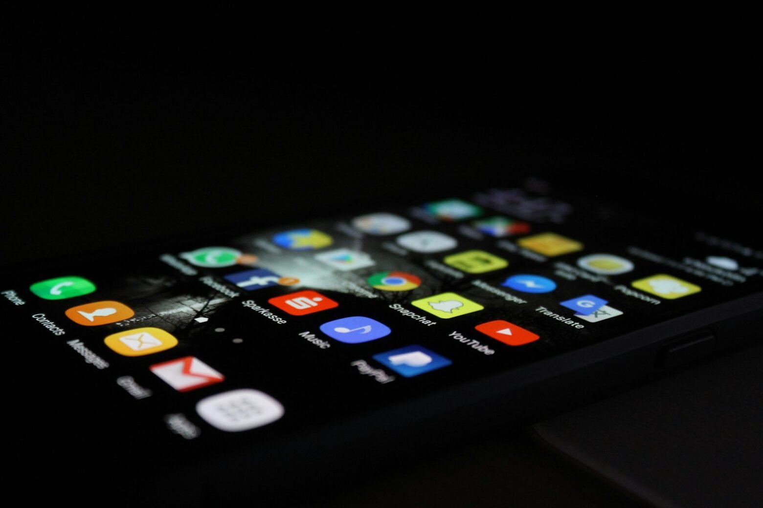 Android smartphone held in hand showing apps