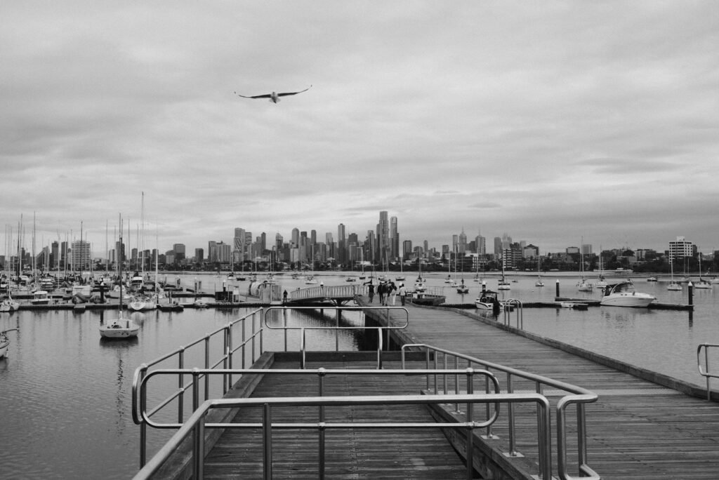 Black and white view of an Australian harbour city skyline from the water